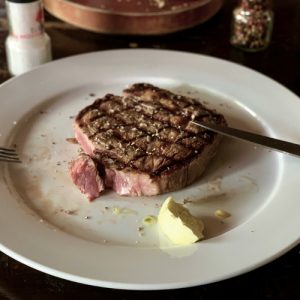 Grilled ribeye steak with garlic butter.